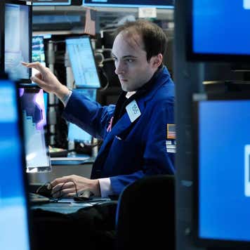 Traders work on the floor of NYSE