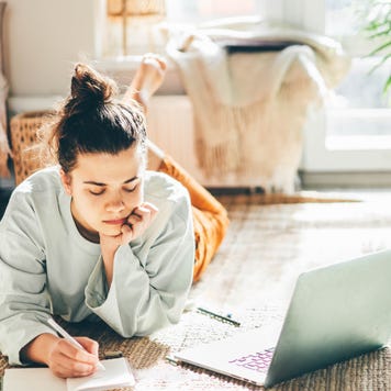 A person researches on a laptop.